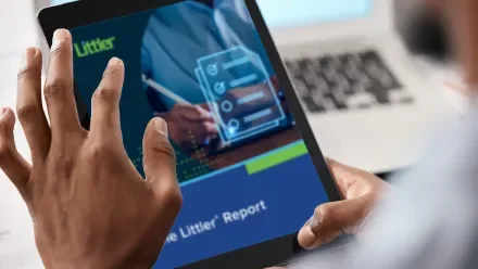 A man reads a Littler Report on a tablet